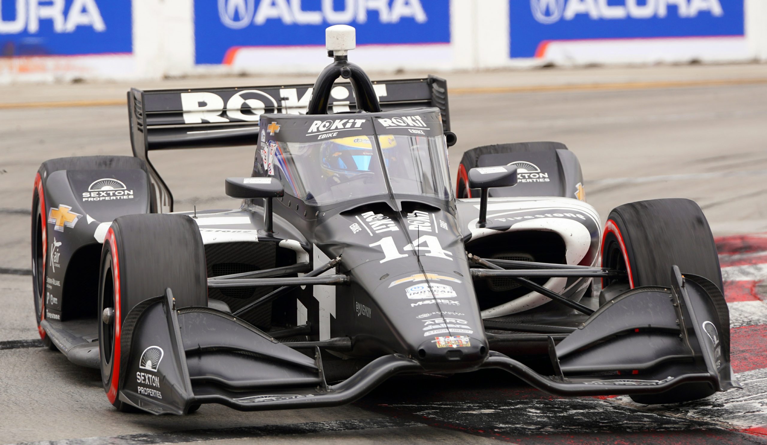 The champ knows how to push hard to make up positions and is doing so here through Turn 1. Notice his left front tire is just off the ground after attacking the berm.